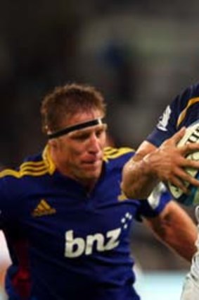 Veteran flanker George Smith of the Brumbies runs past another veteran, Brad Thorn of the Highlanders, during the round nine Super Rugby match in Dunedin.