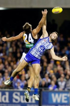 Higher and higher: Ben Griffiths of the Tigers and Luke McDonald of the Kangaroos in an aerial battle for possession.
