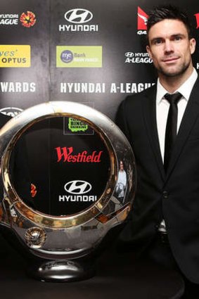 One game away: Michael Beauchamp alongside the Hyundai A-League Championship Trophy.