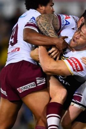 Takedown: Ashton Sims is tackled by Sea Eagles during round 26.