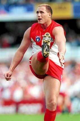Goal machine: Tony Lockett strikes a familiar pose for the Swans, kicking his record-breaking 1300th major in the AFL in 1999.