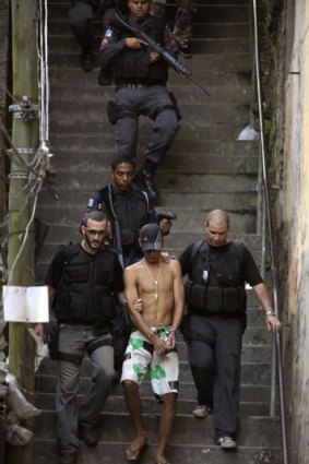 A suspected gang member is arrested in the Morro Santo Amaro slum in Rio de Janeiro.