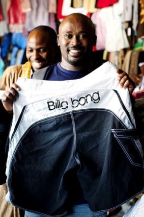 Counting quality ... Polly Kaliisa with a pair of men's Billabong board shorts at Owino market.