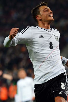 Qualification secured: Mesut Ozil celebrates scoring for Germany against the Republic of Ireland.