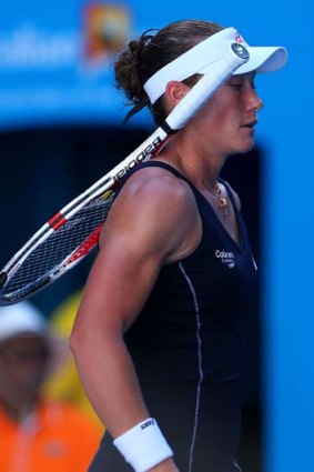 Sam Stosur walks to the net after her loss.