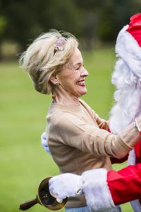 The Governor General Quentin Bryce gives Santa a welcome hug as he arrives at the Children?s Christmas Party at Government House on Wednesday.
