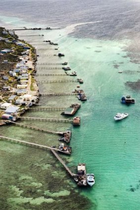 Ragged reefs ... jetties extend from a cluster of Houtman Abrolhos islands.