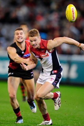 Off the mark: Melbourne’s Colin Sylvia (right) breaks away from Essendon’s Tayte Pears.