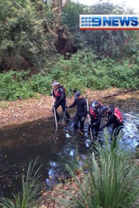Police divers search creeks near Cedar Pocket Road where a man's body was found on Thursday.
