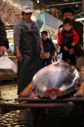 Wholesalers with a bluefin tuna to be sold at Tokyo's Tsukji market.