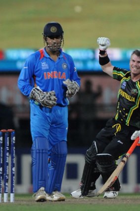 M S Dhoni, captian of India, looks on as David Warner of Australia celebrates after winning the super eight match between Australia and India held at R. Premadasa Stadium on September 28, 2012 in Colombo, Sri Lanka.