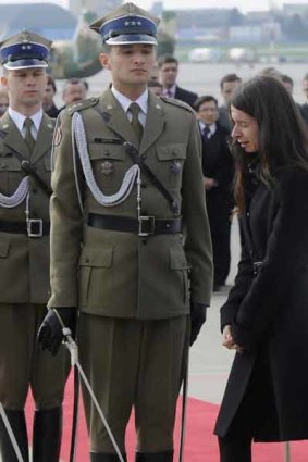 The daughter of the late Polish President Lech Kaczynski, Marta, who lost both her parents in Saturday’s plane crash,  walks past soldiers during a ceremony at the military airport in Warsaw.