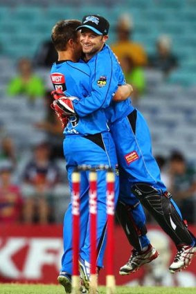 Best keeper in the country? Tim Ludeman of the Strikers is lifted off the ground by teammate Cameron Boyce as they celebrate the wicket of Chris Rogers of the Thunder during the BBL match on December 20.