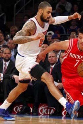 Houston Rockets point guard Jeremy Lin defended by New York Knicks center Tyson Chandler.