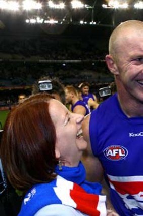 Bulldogs forward Barry Hall and Julia Gillard celebrate after the Dogs defeated North Melbourne at Etihad Stadium on August 1, 2010.