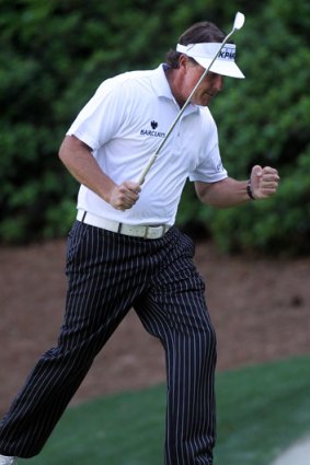 Phil Mickelson pumps his fist after sinking an eagle putt on the 13th hole during the third round of the US Masters at Augusta.
