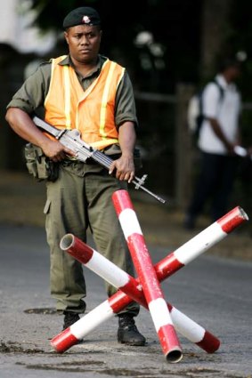 A soldier guards a military checkpoint in Fiji's capital Suva in 2006.