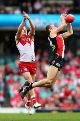 Not this time: Dan Hannebery is outdone by St Kilda's Nathan Wright during the Swans' big win at the SCG on Saturday.