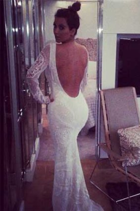 Kim Kardashian has tweeted a picture of herself in a long white dress and the words: "Late night fitting #pucci". Source: @KimKardashian/Twitter