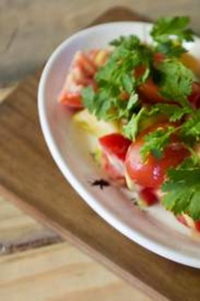 Salad of tomato, pineapple and salted grapes.