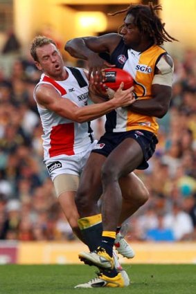 Nic Naitanui of the Eagles looks to fend off a tackle by Jason Gram of the Saints during their round-eight match in Perth.
