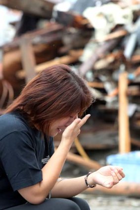 Grief ... a woman prays for victims in Miyagi.