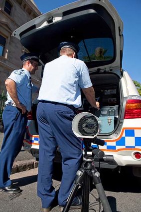 Police officers use the number plate recognition equipment.
