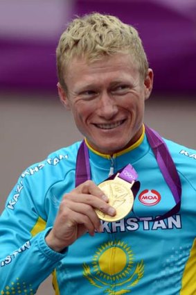 Alexandre Vinokourov holds his gold medal after he won the men's road race at the Olympic Games in London on July 28.