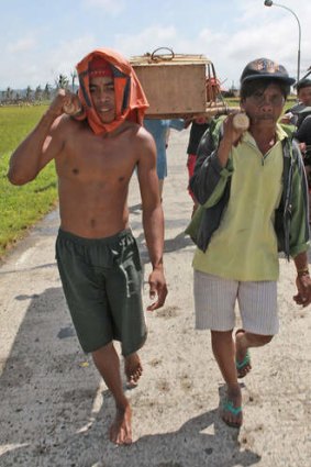 Residents carry a coffin on November 10, 2013 in Santa Fe, Leyte, Philippines.