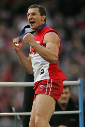Former Swan Leo Barry celebrates after receiving a 2005 AFL premiership medal.