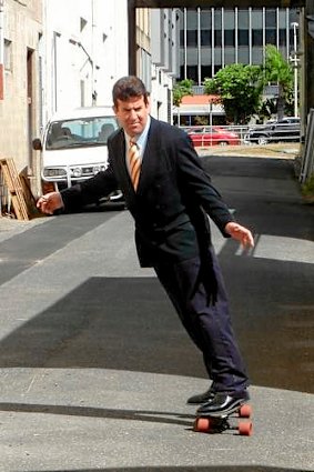 Rockhampton solicitor Brian McGowran rides his skateboard to work.