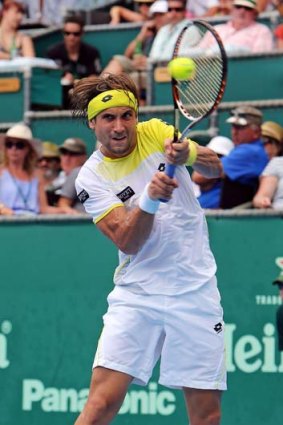 David Ferrer hits a return to Philipp Kohlschreiber of Germany during the men's singles final in Auckland on Saturday.