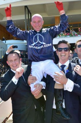 Spring in their steps: Jim Cassidy is chaired by trainer Chris Waller (left) and connections after winning aboard Zoustar.