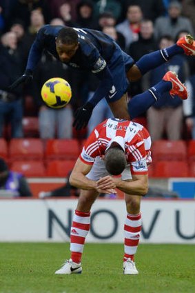 Topsy-turvy season: United defender Patrice Evra goes flying in the defeat at  Stoke.