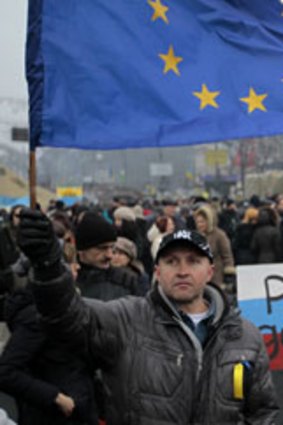A protester at a rally in Independence Square waves the European Union flag.