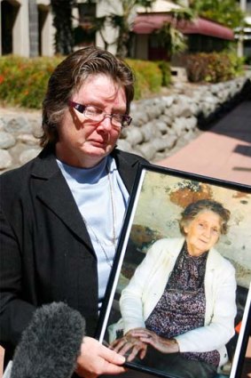 Iris Temperley's daughter, Kerry Bickle, holds a photograph of her mother, who was murdered on Australia Day last year.