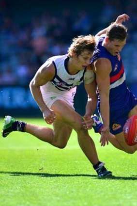 Docker Nathan Fyfe and Bulldog Clay Smith battle for possession.