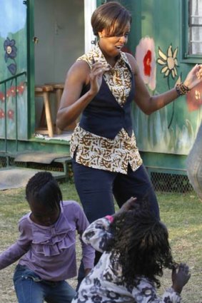 Michelle Obama visits a childcare centre in Johannesburg.
