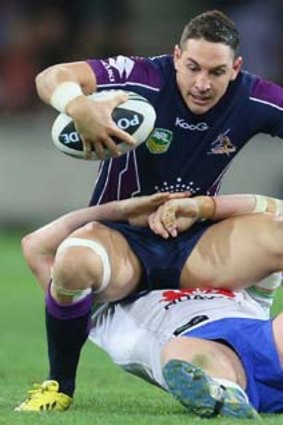 Billy Slater is tackled during the round eight match against the Canberra Raiders.
