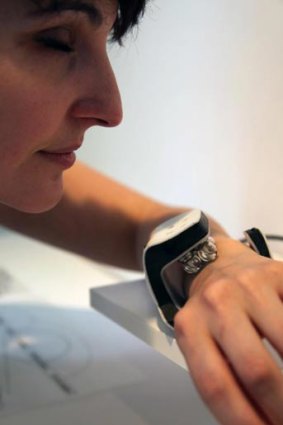 A woman tests a prototype of the Scent Rhythm watch.