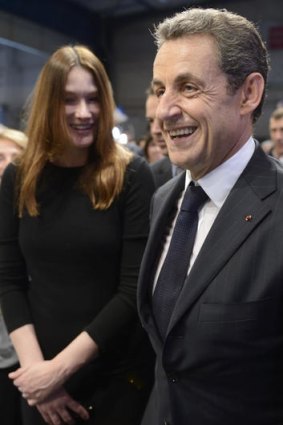 France's President  Nicolas Sarkozy and wife Carla Bruni-Sarkozy leave a campaign meeting in Toulouse.