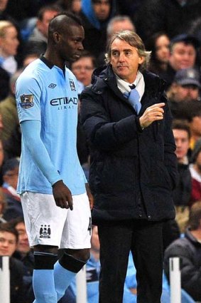 Go and do my bidding: Roberto Mancini prepares to send Mario Balotelli on as a substitute during the game against Watford.