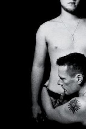Photo by Glen Luchford of Larry Mullen jr embracing his son. This was the cover art for U2's ill-fated <i>Songs of Innocence</i> album.
