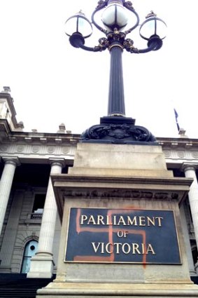 A swastika spray-painted on the Parliament of Victoria sign.
