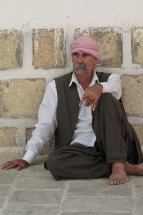 A Yazidi man in the courtyard of Sheikh Adi's shrine, where all must walk with bare feet.
