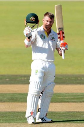 David Warner celebrates after reaching his 100 against South Africa A on July 24.