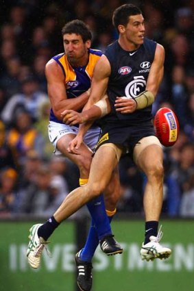 Eagle Dean Cox (left), seen here with Mark Austin of Carlton, played a pivotal role in the win over the Blues.