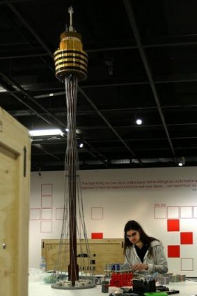 Lego certified model builder Ashley Bogar works on the <i>Towers of Tomorrow</i> exhibition.