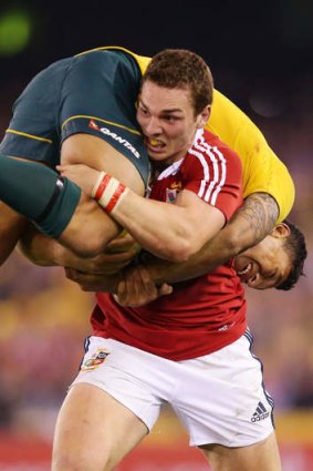 Ball and all: George North takes Israel Folau for a ride.