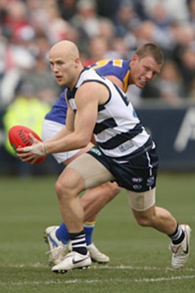 Gary Ablett, of the Cats, runs the ball out of defence against the West Coast Eagles at Skilled Stadium.